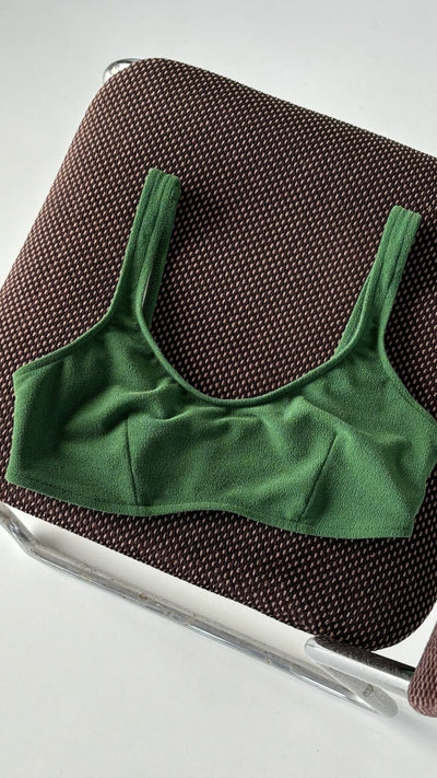 Top deportivo verde del bikini sostenible Mani Palm sobre tumbona - detalle de tejido atoallado reciclado ECONYL - CIRCU